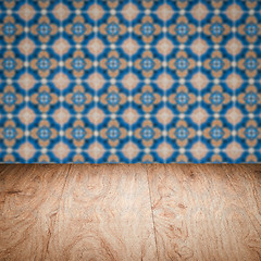 Image showing Wood table top and blur vintage ceramic tile pattern wall