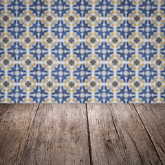 Image showing Wood table top and blur vintage ceramic tile pattern wall