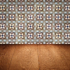 Image showing Wood table top and blur vintage ceramic tile pattern wall