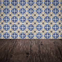 Image showing Wood table top and blur vintage ceramic tile pattern wall