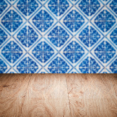 Image showing Wood table top and blur vintage ceramic tile pattern wall