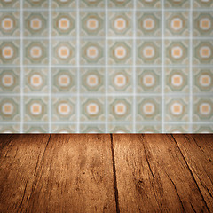 Image showing Wood table top and blur vintage ceramic tile pattern wall