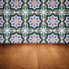 Image showing Wood table top and blur vintage ceramic tile pattern wall