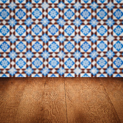 Image showing Wood table top and blur vintage ceramic tile pattern wall