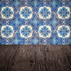 Image showing Wood table top and blur vintage ceramic tile pattern wall