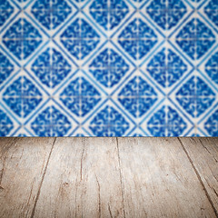 Image showing Wood table top and blur vintage ceramic tile pattern wall