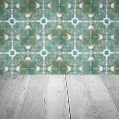 Image showing Wood table top and blur vintage ceramic tile pattern wall