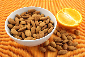 Image showing Fresh almonds and orange