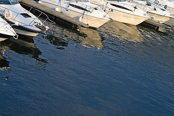 Image showing Motorboats reflections in water