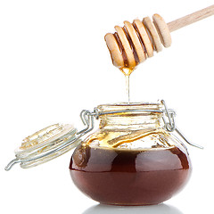 Image showing Jar of honey with wooden drizzler