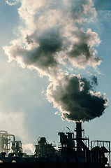 Image showing Smoking chimney  at sunset 