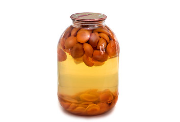 Image showing Home canning: glass cylinders with apricot compote on white back