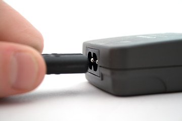 Image showing Connection of a power cable to the device