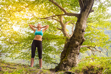 Image showing Active sporty woman relaxing in beautiful nature.
