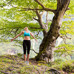 Image showing Active sporty woman relaxing in beautiful nature.