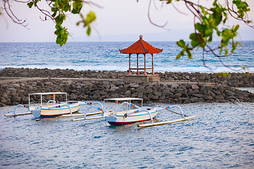 Image showing Traditional Boats Anchored off a Stone Jetty in Bali, Indonesia