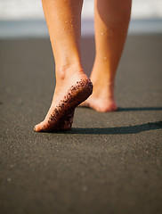 Image showing Wet, Black Sand on a Tourist\'s Foot at a Tropical Beach. Bali, I