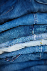 Image showing Jeans in Assorted Shades of Blue, Folded and On Display