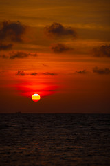 Image showing Red Ball of the Sun Descending towards the Horizon at Sunset