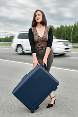 Image showing Beautiful smiling woman with suitcase