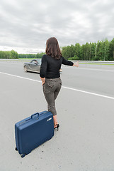 Image showing Beautiful woman with suitcase. Back view