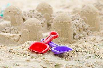 Image showing Sand Castle and the shovels and rake