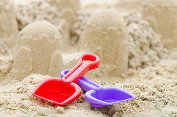 Image showing Shovel and rake on the background of sand castle