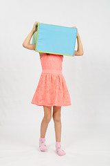 Image showing The girl wore a box on his head