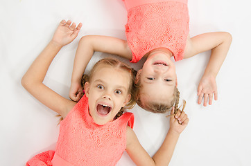 Image showing Two sisters lying on his back   inverted 