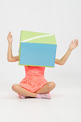 Image showing The girl with a box on his head her arms