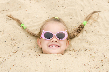 Image showing Five-year girl fell asleep on his head in the sand