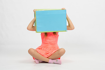 Image showing Girl sitting the floor with a box on his head