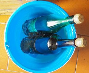 Image showing Bottles of wine in cold water