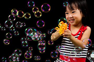 Image showing Asian Chinese Little Girl Playing Soap Bubbles