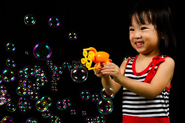 Image showing Asian Chinese Little Girl Playing Soap Bubbles