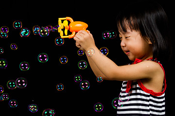 Image showing Asian Chinese Little Girl Playing Soap Bubbles