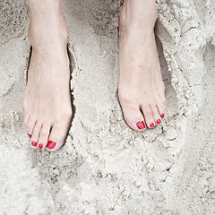 Image showing woman feet on the sand