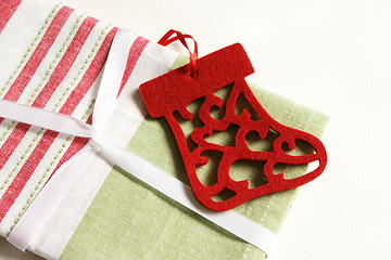 Image showing Christmas gift wrapped in fabric and ribbon.