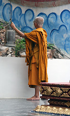 Image showing monk ringing the bell