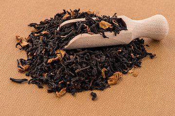 Image showing Black Dry Tea with a Wooden Spoon