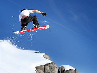 Image showing Snowboarder jumping