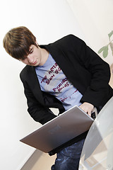 Image showing confident young manager at work with laptop