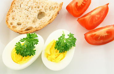 Image showing Simple meal. Eggs, bread and tomatos.