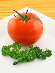 Image showing Fresh tomato and parsley on a plate