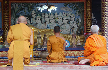 Image showing three monks pray