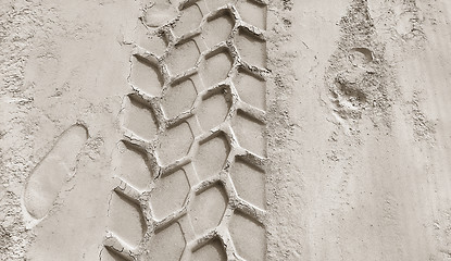 Image showing Wheel track and footprints on the sand