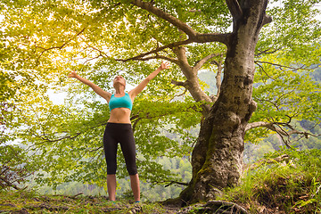 Image showing Active sporty woman relaxing in beautiful nature.