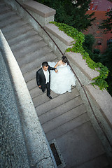 Image showing Newlyweds walking down stone steps