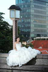 Image showing Bride sitting next to street lamp