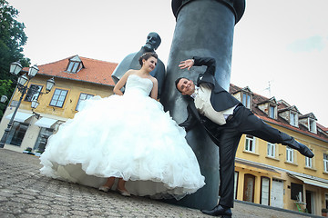 Image showing Bride and groom goofing in front of August Senoa Monument